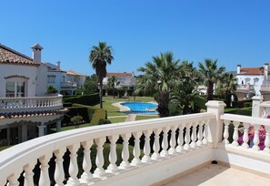 A pool surrounded by manicured gardens and white buildings with red-tiled roofs. - 'Lovely Villa in Family Resort' with Pool, Garden & Wi-Fi (Miami Playa)