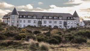 A large, multi-story building with a symmetrical facade, multiple windows, and a prominent central tower. - Aurora View (Forres)