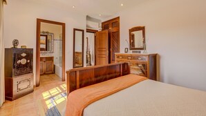 A bedroom with a bed, wooden dresser, and a mirror. - Son Blai Petit by Rentallorca (Muro)