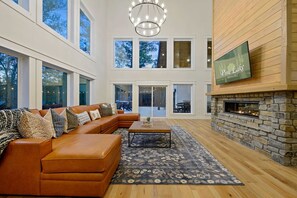 Relax in this inviting living area with a cozy fireplace, comfortable sofa, and stunning views.