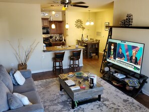 Relax in this cozy living space with a sofa, coffee table, and TV.