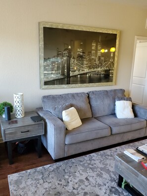 Relax in this stylish living room with a sofa, side table, and coffee table.