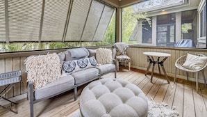 A covered porch with a sofa, chairs, and a table. - Beautiful 2nd Row Beach Home w/ Beautiful Views (Hilton Head Island)