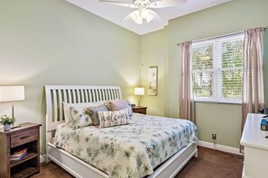 A bedroom with a bed, bedside tables, a nightstand, a desk, and a window with curtains. - Gorgeous Updated 2 Bedroom Lake View Unit in (Isla Del Sol)
