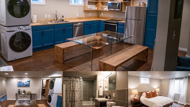 A modern kitchen with blue cabinets, a glass-top table, and stainless steel appliances. - Charming 2-Bedroom Apartment – Minutes to Downtown & MSU! (Bozeman)