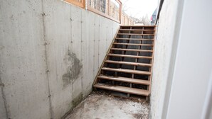 A concrete stairway leading to a wooden deck. - Charming 2-Bedroom Apartment – Minutes to Downtown & MSU! (Bozeman)