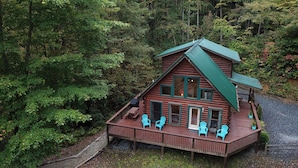 A cabin with a deck, multiple windows, and outdoor seating. - Spectacular year-round views of Smokey Mountain National Park from a D-Log Cabin (Whittier)