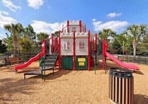 A playground with slides and climbing structures. - Disney South facing Pool Home, 5 minutes from Disney, Complimentary pool Heat! (Kissimmee)