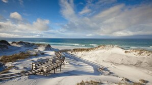A beach with a wooden boardwalk leading to a sandy area with benches. - Escapeto30A/GolfCartIncluded/Pool/WalkToBeach (Santa Rosa Beach)