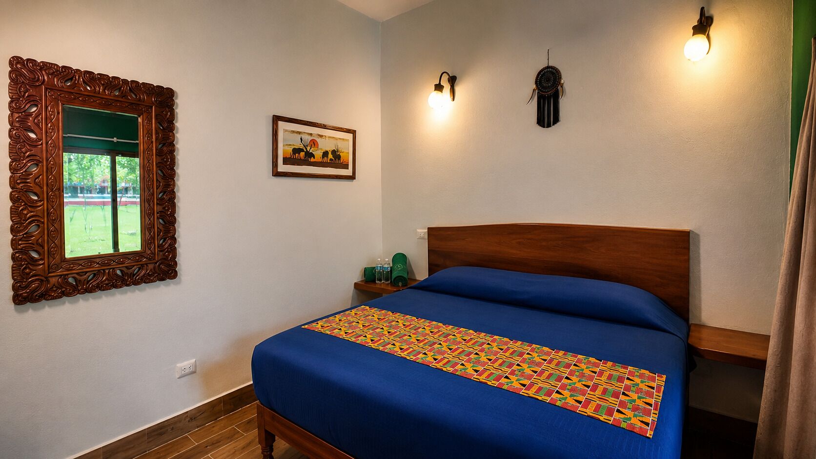 A bedroom with a wooden bed, a decorative mirror, a wall-mounted light, and a framed picture.