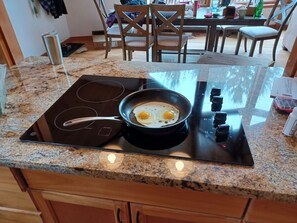 Enjoy cooking in this well-equipped kitchen with a modern induction cooktop and ample dining space.