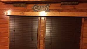 Der Eingang einer Holzhütte, mit einem Schild, auf dem 'CABIN' steht.