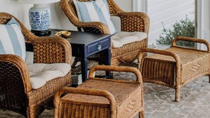 A room with wicker furniture, a large mirror, and framed pictures on the wall. - Waterfront Rappahannock River Cottage, Private Pool, Kayaks, Fire Pit & Garden (Locust Hill)