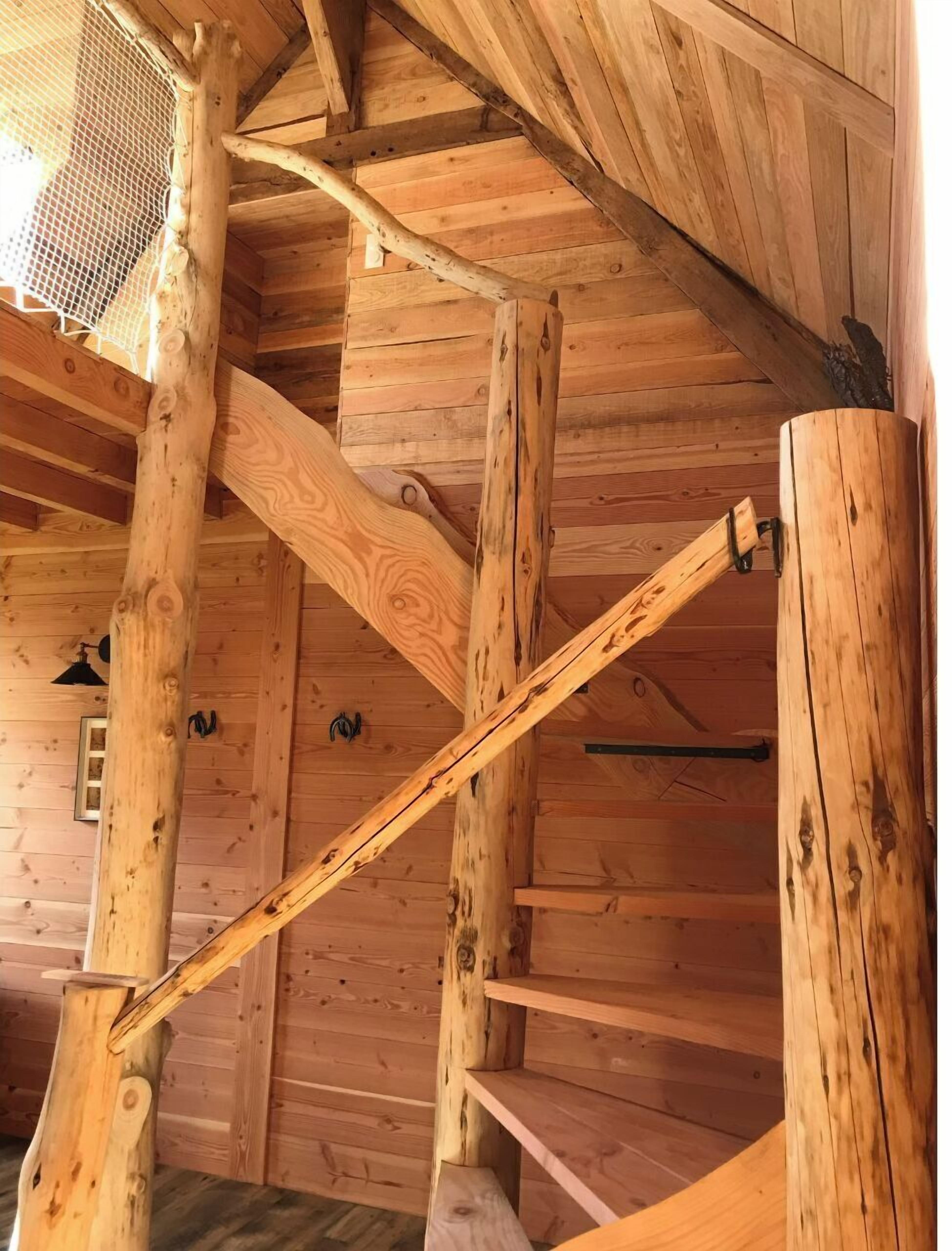 A wooden interior with a sloped ceiling and wooden beams.