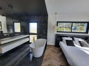 Bathtub, hair dryer, towels, toilet paper