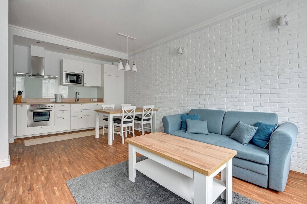 A modern apartment with a kitchen, dining area, and living room.