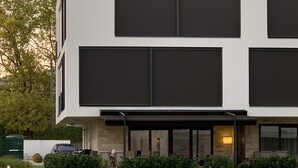 A modern two-story building with large windows and a flat roof. - Lakeside condo with beach access (Csopak)