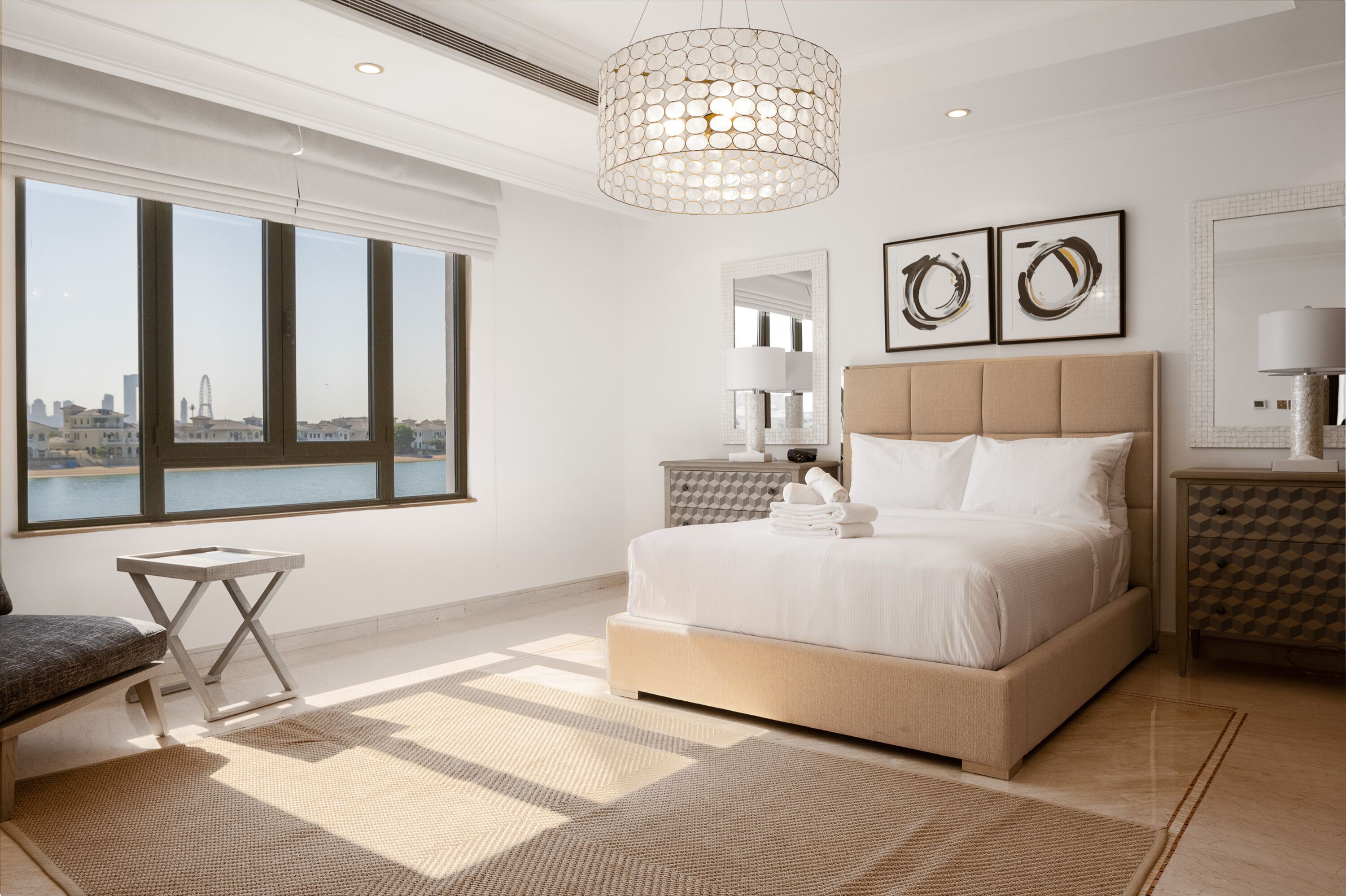 A modern bedroom with a large bed, a view of the city, and a cityscape through the window.