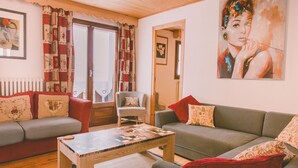 A cozy living room with a sofa, armchair, and a coffee table.