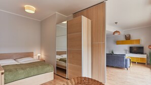 Un dormitorio moderno con cama, mesita de noche y armario.