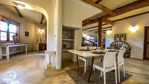 A spacious dining area with a high ceiling, exposed wooden beams, and a central table with chairs. - Casa Noa master suite 3 steps from the sea (Tulum)