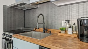 A modern kitchen with a stainless steel sink, a built-in oven, and a coffee maker. - HOLT - Billionaire Mountain (Aspen)