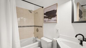A bathroom with a bathtub, toilet, and sink. - HOLT - Billionaire Mountain (Aspen)