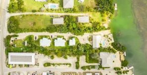 An aerial view of a coastal property with multiple buildings, a swimming pool, and a beach area. - Old Florida Style, Dockage, Swimming Pool (shared), just 20 miles from Key West (Cudjoe Key)