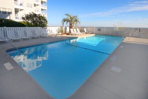 Relax by the pool surrounded by comfortable lounge chairs.
