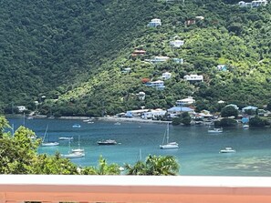 A coastal village with houses on a hillside overlooking a body of water with boats. - BLUE KAI, Water View, 2 King Suites Outdoor Native Stone Showers (St John)