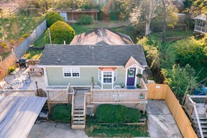 A two-story house with a front porch, a small deck, and a staircase leading to the front door. - WALK EVERYWHERE in North Chat! -VIEWS- 2 KING Beds (Chattanooga)