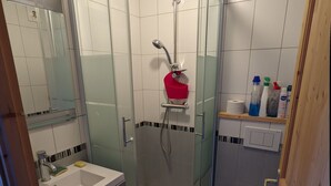 A modern bathroom with a glass-enclosed shower, a white sink, and a toilet. - Avoriaz - charming studio with balcony in the heart of the resort (Morzine)