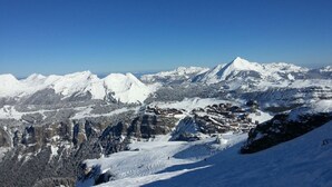 A snow-covered mountain landscape with a town nestled in the valley. - Avoriaz - charming studio with balcony in the heart of the resort (Morzine)
