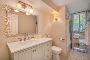 Bathtub, hair dryer, towels, soap