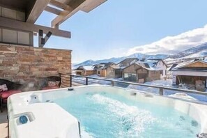 A hot tub with a view of snow-covered houses and mountains in the background. - Private Hot Tub, Views of the Lake, just min to Main St!, Private Hot Tub, Views of the Lake, just m (Hideout)