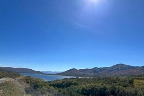 Ein klarer Blick auf einen See, umgeben von Bergen und dichtem Wald.