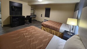 A hotel room with two beds, a desk with a chair, a television, and a lamp. - Green Garden Inn (Greensboro)