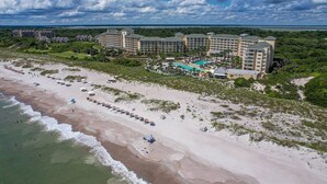 A resort with multiple buildings, a beach, and a pool area.