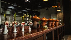 A kitchen counter with vases and terracotta pots. - Room-kori Maharani Villas - One-bedroom (Gianyar)