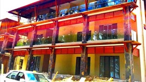 A multi-story building with a red roof and balconies. - West Front One No 4 With Seafront Beachfront Licensed By Tourism Authority 14977 (Flic-en-Flac)
