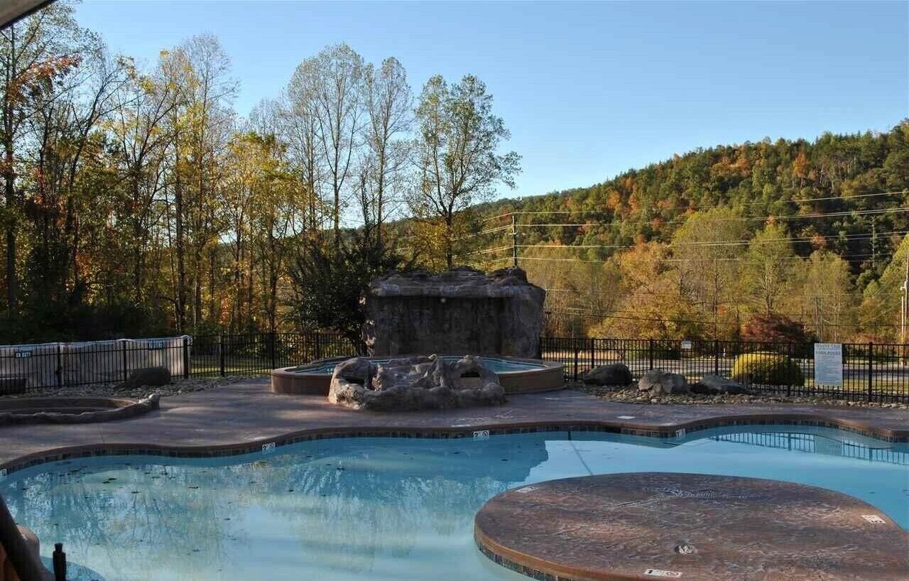 Una piscina con un paisaje natural al fondo.
