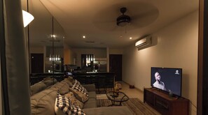 Una sala de estar moderna con un sofá, una mesa de centro y un televisor.