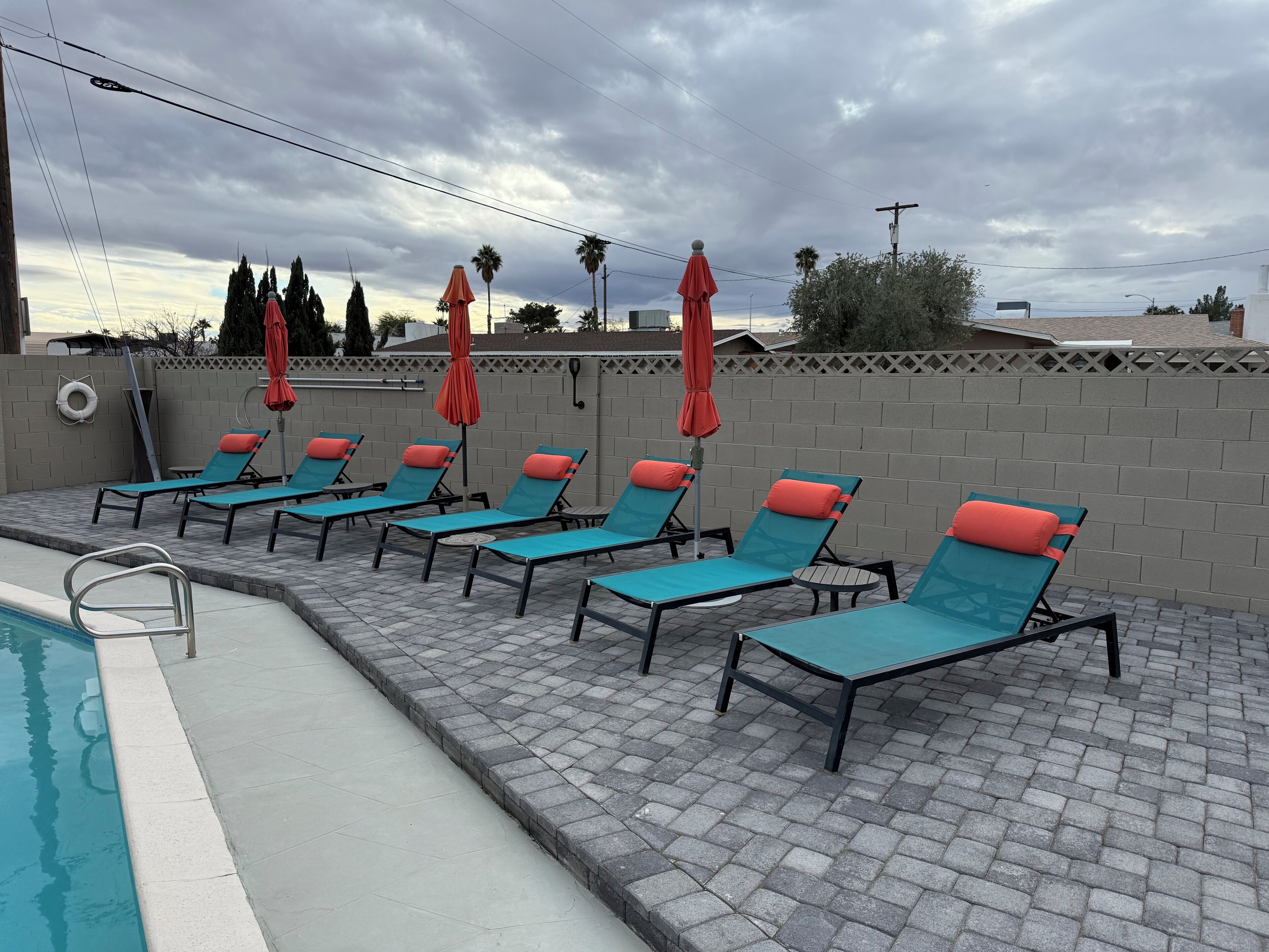A poolside area with lounge chairs and umbrellas.