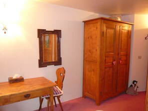 A wooden cabinet, a wooden chair, a wooden table, and a mirror on a wall. - CENTRE Beautiful 4-room 4* chalet for 6 people, CLOSE TO EVERYTHING (Valloire)
