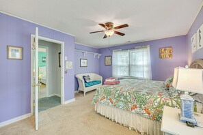 A bedroom with a bed, a chair, a desk, and a ceiling fan. - 'Reel Blessed' Topsail Beach Home w/ Private Dock! (Topsail Beach)