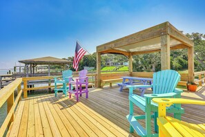 A wooden deck with Adirondack chairs, a gazebo, and a view of the water. - 'Reel Blessed' Topsail Beach Home w/ Private Dock! (Topsail Beach)