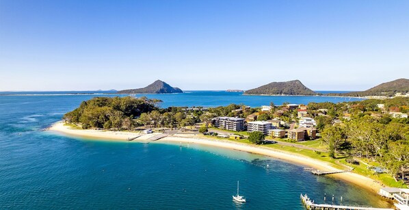 Enjoy ocean views from the balcony of your accommodation, surrounded by lush greenery and a scenic island backdrop.