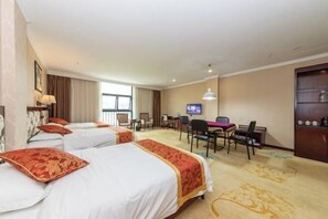 A hotel room with three beds, a desk, a television, and a minibar. - Jingxi Global Hotel (Jingxi)