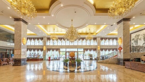 A spacious lobby with marble flooring, a central decorative fountain, and ornate chandeliers. - Jingxi Global Hotel (Jingxi)