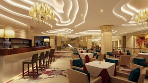 A hotel lobby with a bar area, seating arrangements, and a modern ceiling design. - Jingxi Global Hotel (Jingxi)